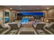 Outdoor living space with a covered patio, in-ground pool, spa, and outdoor kitchen at 10096 Amethyst Hills St, Las Vegas, NV 89148