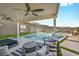 Spacious patio with a luxurious pool with a waterfall and ample seating, ideal for outdoor living at 10096 Amethyst Hills St, Las Vegas, NV 89148
