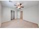 Bright bedroom with a ceiling fan, carpeted floors, and an open closet space at 10418 Poplar Park, Las Vegas, NV 89166