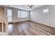 Bright living room with wood floors, white walls, and a glass door to the exterior at 10418 Poplar Park, Las Vegas, NV 89166