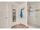 Bathroom with a walk-in shower, a decorative mirror, and tile flooring at 10445 Skye Canyon Falls Ave, Las Vegas, NV 89166