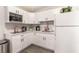 Modern kitchen with new white cabinets, stainless steel appliances, and light countertops at 1216 Oahu St, Las Vegas, NV 89104