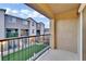 Balcony view showcasing the community courtyard, manicured lawns, and well-maintained exteriors of adjacent townhomes at 12305 Crimson Horizon Rd # 4, Las Vegas, NV 89183