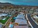 Extensive Las Vegas neighborhood, showing backyard oasis with pool and firepit at 12356 Grey Dunes Ave, Las Vegas, NV 89138