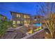 Expansive backyard featuring a pool, patio, fire pit, and lush desert landscaping, creating a serene outdoor oasis at 12356 Grey Dunes Ave, Las Vegas, NV 89138