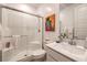 Modern bathroom featuring a glass shower, white subway tile, and a white vanity with a sink at 12356 Grey Dunes Ave, Las Vegas, NV 89138