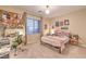 Cozy carpeted bedroom featuring a study desk, closet and a window at 12356 Grey Dunes Ave, Las Vegas, NV 89138
