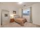 Simple carpeted bedroom has large window, closet, with a light fixture at 12356 Grey Dunes Ave, Las Vegas, NV 89138