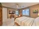 Comfortable bedroom features soft carpet, neutral walls, and a ceiling fan with light at 12356 Grey Dunes Ave, Las Vegas, NV 89138