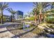 Serene community space with water feature, palm trees, and modern architecture at 12356 Grey Dunes Ave, Las Vegas, NV 89138