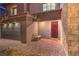 Charming front entrance with a covered porch, brick walkway, and a bench at 12356 Grey Dunes Ave, Las Vegas, NV 89138