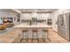 Bright open kitchen featuring a large marble island, stainless steel appliances, and modern white cabinetry at 12356 Grey Dunes Ave, Las Vegas, NV 89138