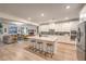 Modern kitchen with a large island and stainless steel appliances open to a living space at 12356 Grey Dunes Ave, Las Vegas, NV 89138