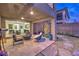 Inviting covered outdoor patio with comfortable seating and seamless transition to the home's interior at 12356 Grey Dunes Ave, Las Vegas, NV 89138