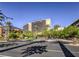 Lush landscaping and mature trees leading to a grand resort hotel at 12356 Grey Dunes Ave, Las Vegas, NV 89138
