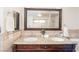 Bathroom featuring a double sink vanity with a granite countertop and decorative mirror at 1561 Doran Dr, Las Vegas, NV 89123