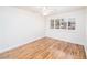 Bright bedroom with wood floors and a window with plantation shutters at 1561 Doran Dr, Las Vegas, NV 89123