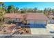 Well-maintained single-story home featuring a three-car garage and desert-friendly landscaping at 1561 Doran Dr, Las Vegas, NV 89123