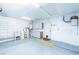 Spacious garage featuring a utility sink, ample cabinet space, and access to the home's interior at 1561 Doran Dr, Las Vegas, NV 89123