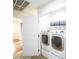 Bright laundry room with stacked washer and dryer units and ample storage space at 1561 Doran Dr, Las Vegas, NV 89123