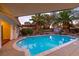 Beautiful backyard oasis with a pool, mature palms, landscaping, and ample privacy at 1561 Doran Dr, Las Vegas, NV 89123