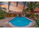 Relaxing backyard with a large sparkling pool and covered patio, ideal for leisure and entertainment at 1561 Doran Dr, Las Vegas, NV 89123