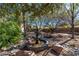 Backyard water fountain landscaped with rocks and mature trees, creating a peaceful oasis at 1561 Doran Dr, Las Vegas, NV 89123