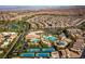 Aerial view of a Primary-planned community with pools, tennis courts, green spaces, and residential homes at 201 White Mule Ave, Las Vegas, NV 89148