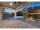 Landscaped backyard with a pool, spa, fire pit, and covered patio with string lights for outdoor entertaining at 201 White Mule Ave, Las Vegas, NV 89148