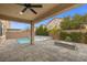Outdoor patio with a pool, spa, fire pit, and covered seating area with lights at 201 White Mule Ave, Las Vegas, NV 89148