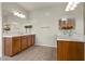 Bathroom with double sinks, wood cabinets, and large mirrors with decorative vases at 201 White Mule Ave, Las Vegas, NV 89148