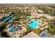 Beautiful aerial view of a community pool area with waterslides, sports courts, and plentiful seating at 201 White Mule Ave, Las Vegas, NV 89148