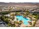 Aerial view showcasing a resort-style pool with water slides, lush landscaping, and community amenities at 201 White Mule Ave, Las Vegas, NV 89148