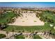 Expansive aerial view of a well-designed golf course, with lush fairways, manicured greens, and towering palm trees at 201 White Mule Ave, Las Vegas, NV 89148