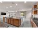 Well-equipped kitchen boasting a center island with a sink, stainless steel appliances, and convenient access to the patio at 201 White Mule Ave, Las Vegas, NV 89148