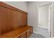Mud room with convenient wooden bench with coat hooks, and storage below. Located adjacent to entrance to bathroom at 201 White Mule Ave, Las Vegas, NV 89148