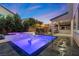 Inviting backyard pool with inset lighting, spa, lounge chairs, covered patio, and outdoor kitchen at 201 White Mule Ave, Las Vegas, NV 89148