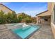 Backyard pool and spa with a swim-up tanning deck, built-in grill, and covered seating area at 201 White Mule Ave, Las Vegas, NV 89148