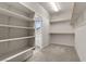 Carpeted walk-in closet with ample shelving, hanging rods, and natural light at 201 White Mule Ave, Las Vegas, NV 89148