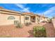 Home's backyard boasts desert landscaping, covered patio, and privacy fence providing a private outdoor space at 213 N Cimarron Rd, Las Vegas, NV 89145