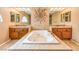 This spa-like main bathroom offers dual sinks, tiled floors, and a large tub with jets at 213 N Cimarron Rd, Las Vegas, NV 89145