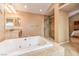 This spacious main bathroom features a separate glass shower and a tiled garden tub at 213 N Cimarron Rd, Las Vegas, NV 89145