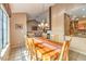 The dining room features tile floors, a wooden table and access to the kitchen at 213 N Cimarron Rd, Las Vegas, NV 89145