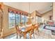 Bright dining room featuring tile floors, a large window, and a wood table at 213 N Cimarron Rd, Las Vegas, NV 89145
