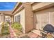 Charming home exterior showing the side yard with low maintenance landscaping, a grill, and a covered patio at 213 N Cimarron Rd, Las Vegas, NV 89145
