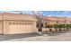 Charming single-story house featuring a two-car garage, desert landscaping, and tile roof at 213 N Cimarron Rd, Las Vegas, NV 89145