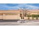 A well-maintained single-story house with tile roof, desert landscaping, and attached garage at 213 N Cimarron Rd, Las Vegas, NV 89145