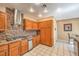 This kitchen is equipped with tile floors, a stainless range hood, and wooden cabinetry at 213 N Cimarron Rd, Las Vegas, NV 89145