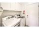 Convenient laundry room with a full-size washer and dryer, storage cabinets above, and access to the garage at 213 N Cimarron Rd, Las Vegas, NV 89145