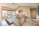 Cozy living room featuring vaulted ceilings, tile floors, large windows, and comfortable seating at 213 N Cimarron Rd, Las Vegas, NV 89145